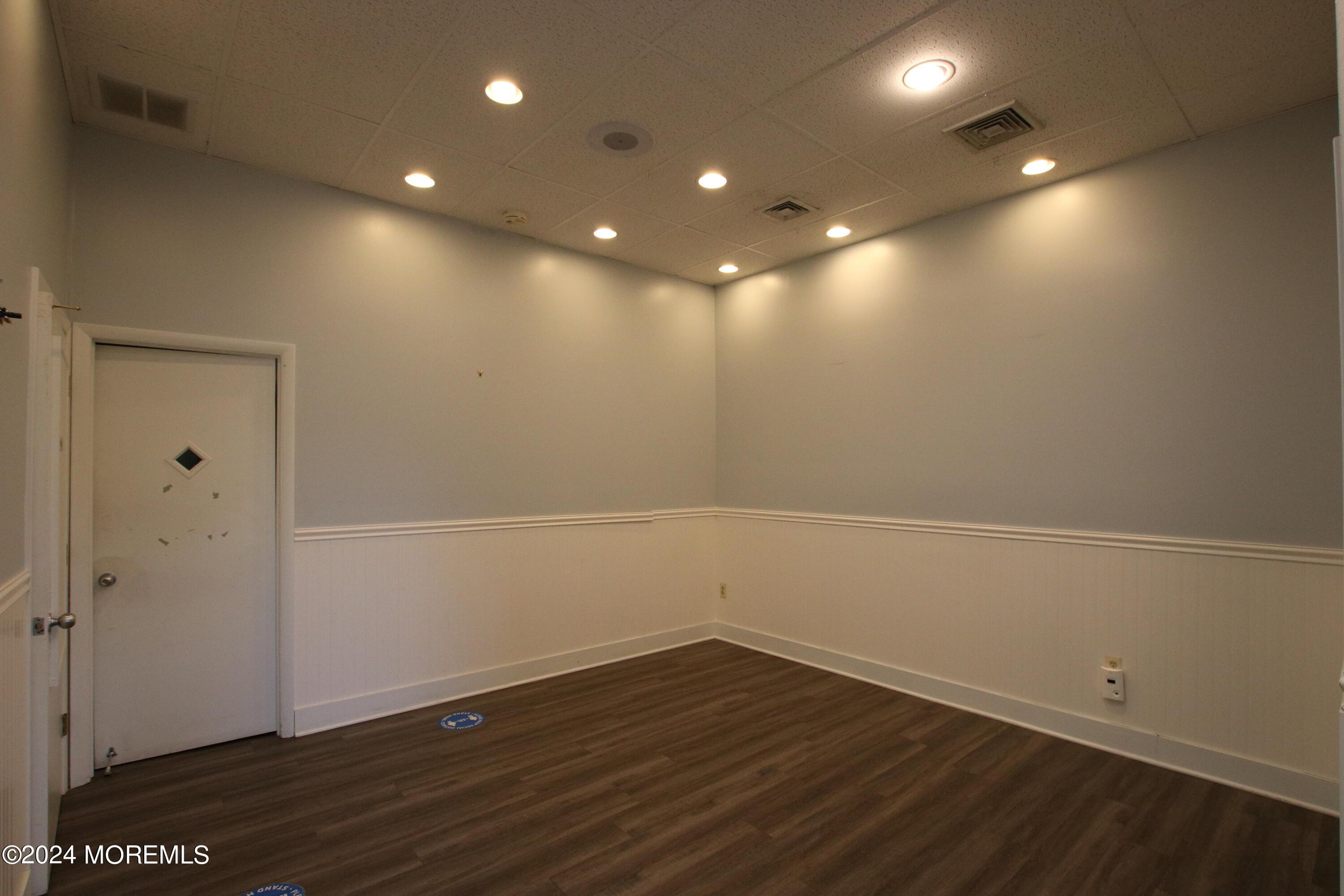 Waiting room with recessed lighting and laminate flooring. Restroom just for Waiting area.